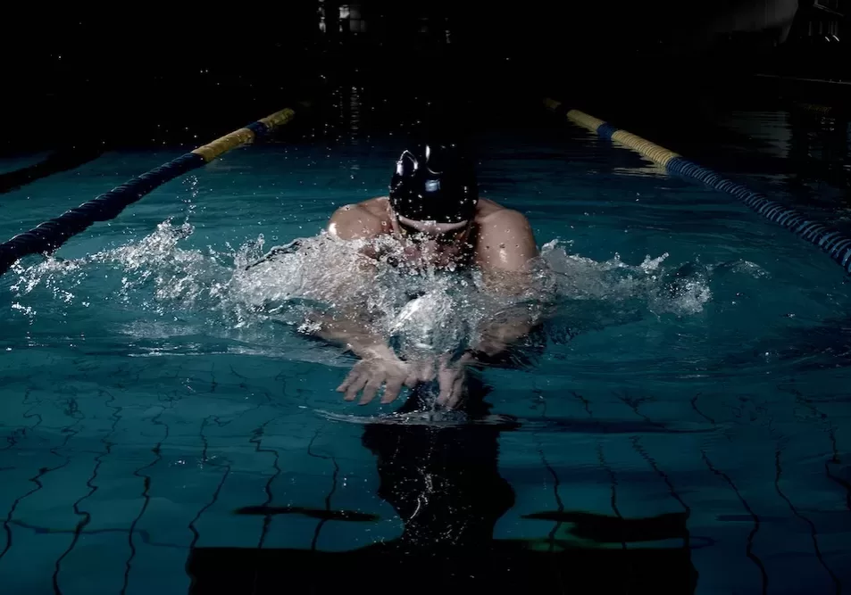 Sportsman swims in a swimming pool